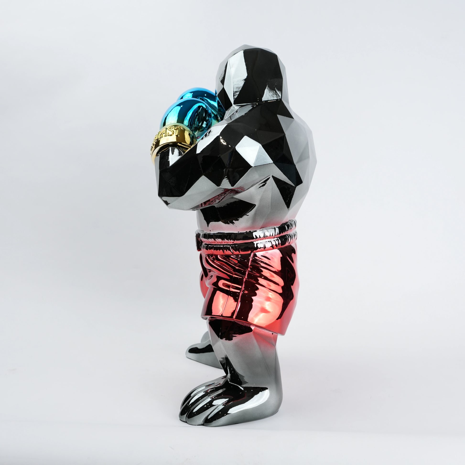 Electroplated resin gorilla boxer figurine in a strong upright stance with raised boxing gloves, featuring a reflective multicolor metallic finish, detailed muscular form, and smooth high-gloss surface designed as a bold modern decor piece.