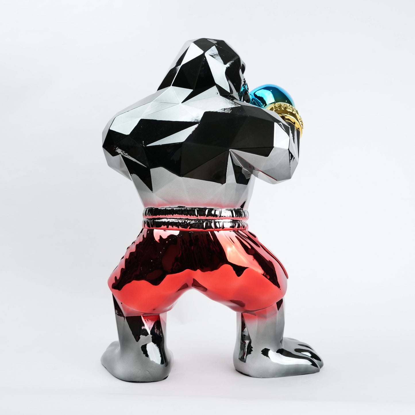 Electroplated resin gorilla boxer figurine in a strong upright stance with raised boxing gloves, featuring a reflective multicolor metallic finish, detailed muscular form, and smooth high-gloss surface designed as a bold modern decor piece.