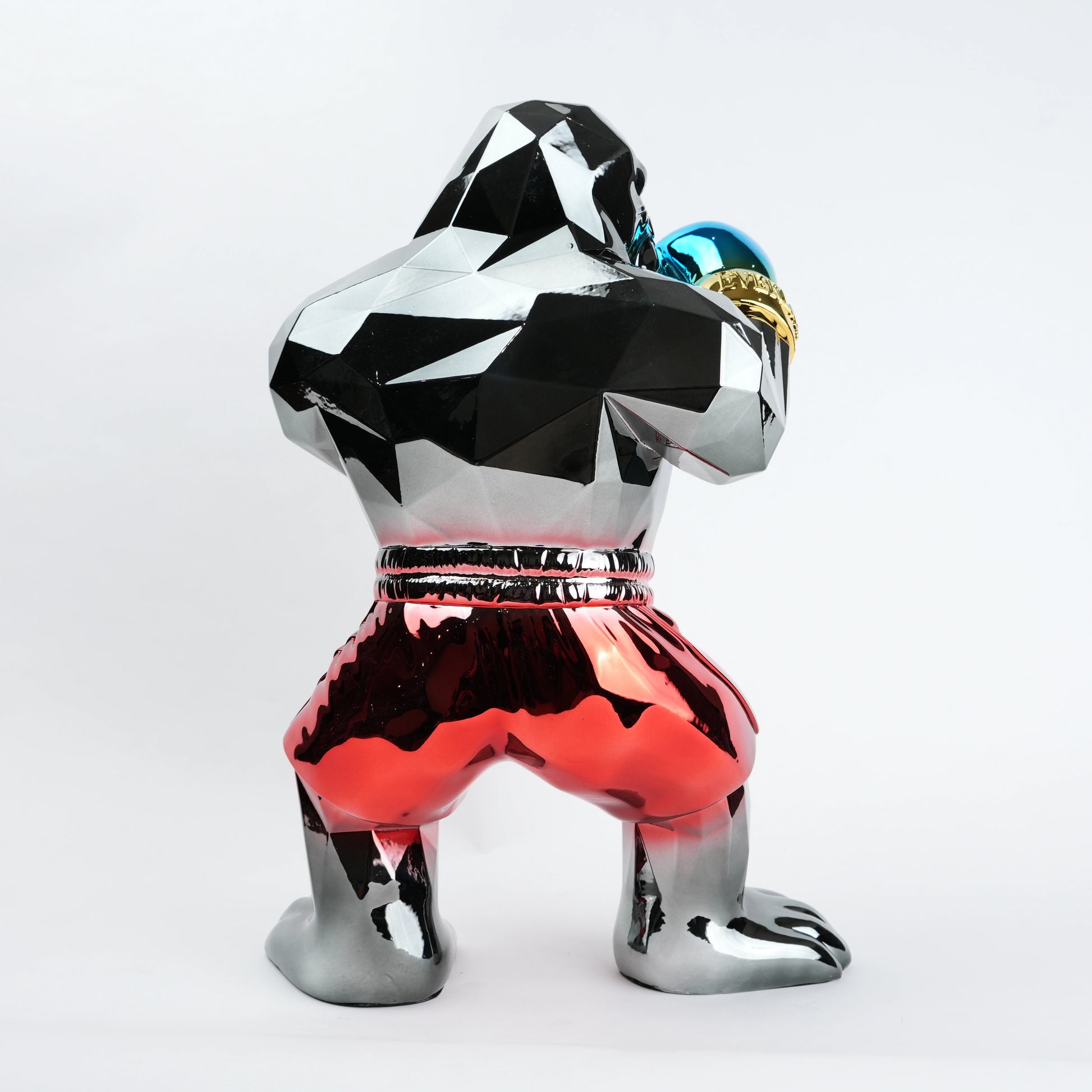 Electroplated resin gorilla boxer figurine in a strong upright stance with raised boxing gloves, featuring a reflective multicolor metallic finish, detailed muscular form, and smooth high-gloss surface designed as a bold modern decor piece.