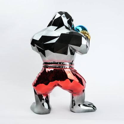 Electroplated resin gorilla boxer figurine in a strong upright stance with raised boxing gloves, featuring a reflective multicolor metallic finish, detailed muscular form, and smooth high-gloss surface designed as a bold modern decor piece.