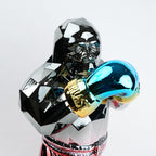 Electroplated resin gorilla boxer figurine in a strong upright stance with raised boxing gloves, featuring a reflective multicolor metallic finish, detailed muscular form, and smooth high-gloss surface designed as a bold modern decor piece.