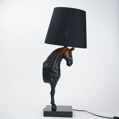Horse-shaped table lamp with a black shade on a white background