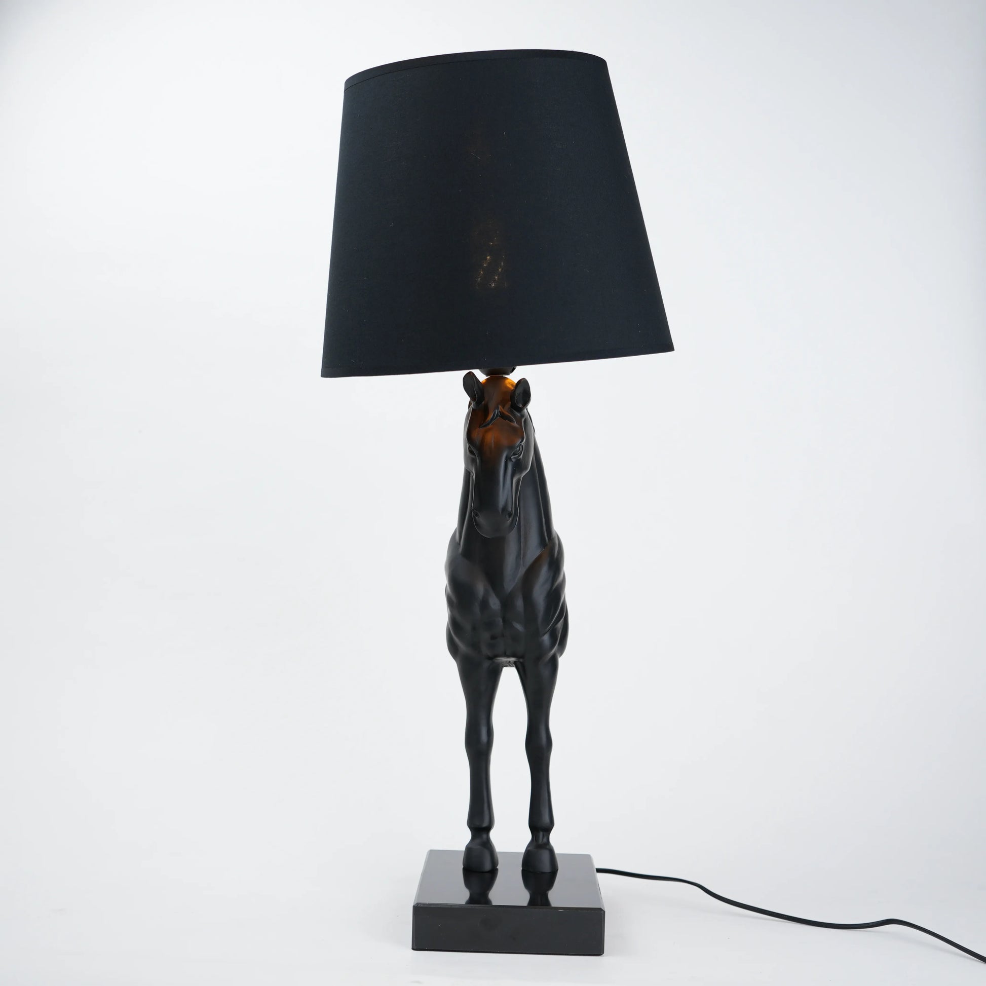 Horse table lamp featuring a detailed horse-shaped base with a premium finish, paired with a fabric lampshade that provides soft ambient lighting, designed as a decorative and functional lighting piece.