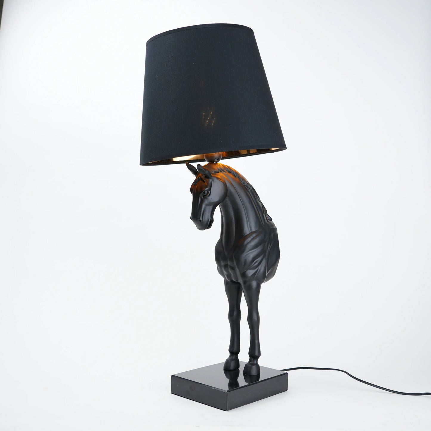 Horse table lamp featuring a detailed horse-shaped base with a premium finish, paired with a fabric lampshade that provides soft ambient lighting, designed as a decorative and functional lighting piece.