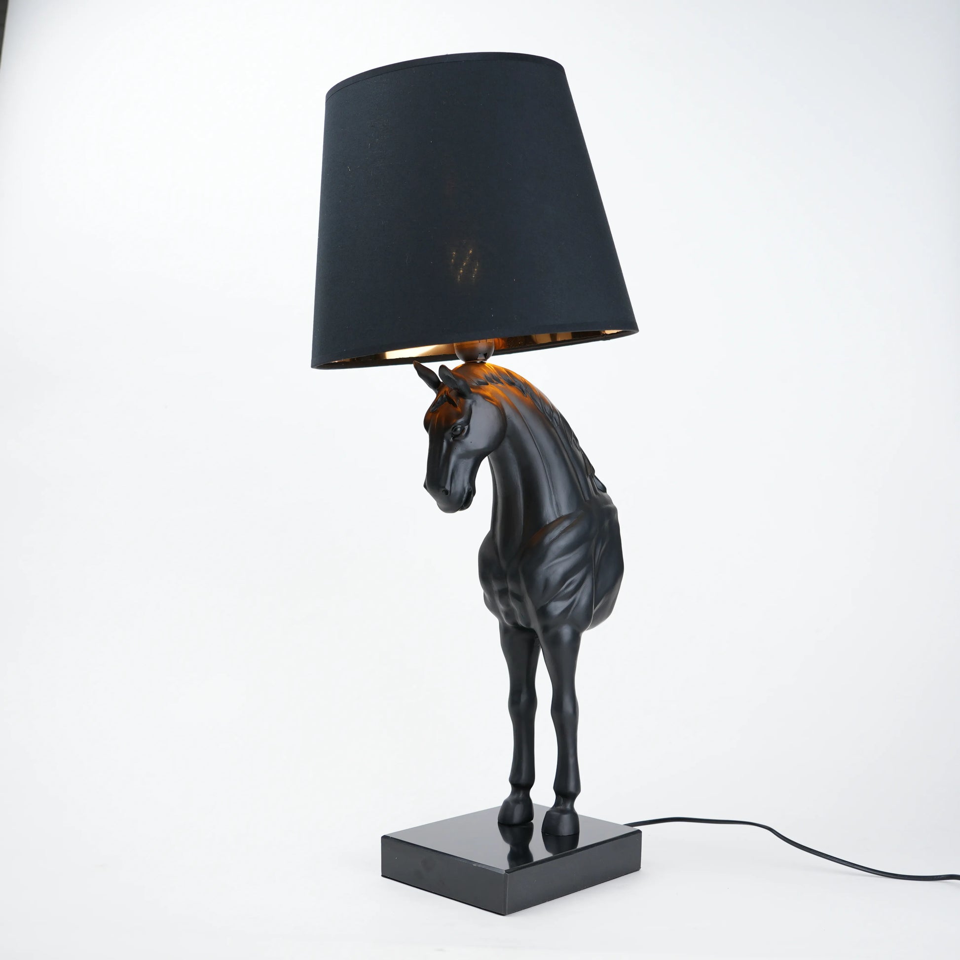 Horse table lamp featuring a detailed horse-shaped base with a premium finish, paired with a fabric lampshade that provides soft ambient lighting, designed as a decorative and functional lighting piece.