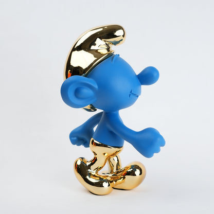 Blue Smurf figurine with a gold hat and shoes on a white background