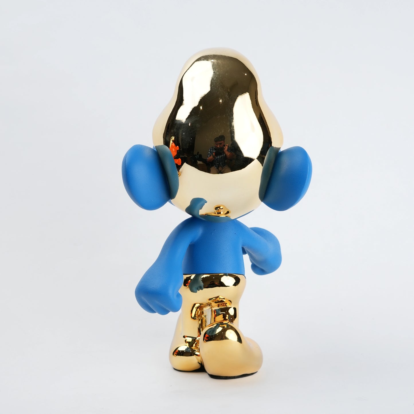 Blue and gold figurine on a white background