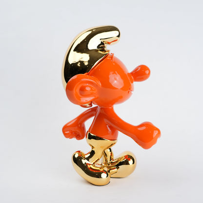 Orange and gold figurine on a white background