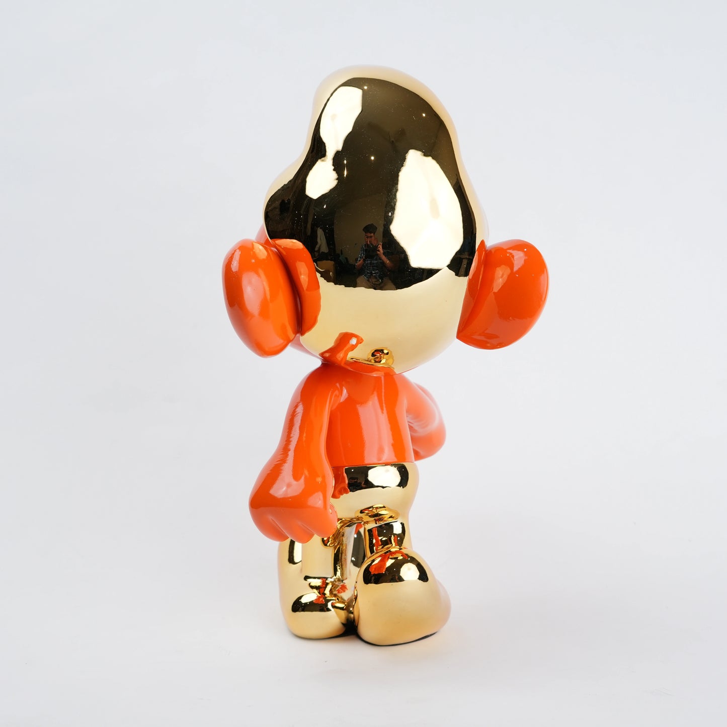 Gold and orange character figurine on a white background