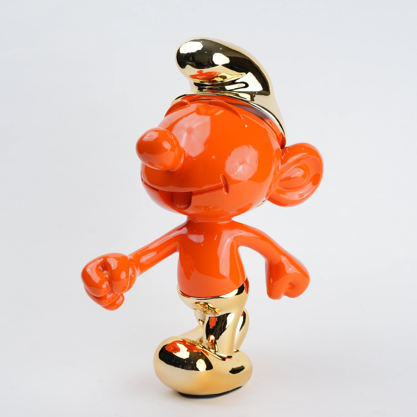 Orange character figurine with gold accents on a light gray background