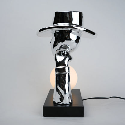Modern table lamp with a reflective metallic design on a gray background