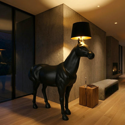 Matte black horse floor lamp with a sculptural design and top-mounted shade, creating a modern statement lighting piece for luxury interiors.