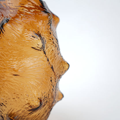Amber hammered vase macro, spiny texture