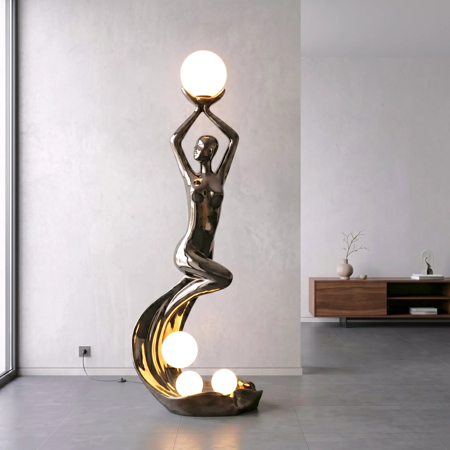 black sculptural floor lamp with human figure and orb lights