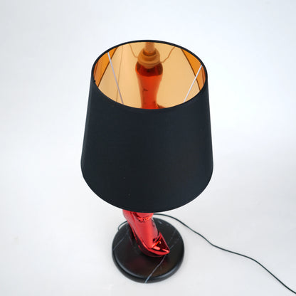Table lamp with black base and shade on a white background