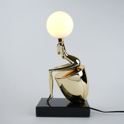 gold figure table lamp with orb light modern decor
