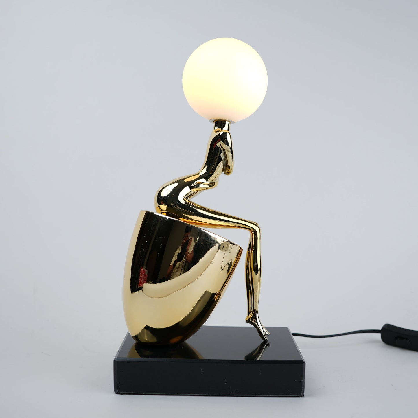 gold figure table lamp with orb light modern decor