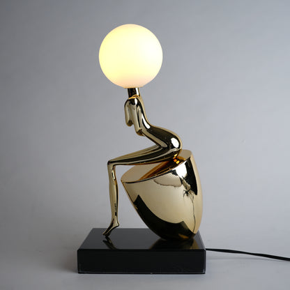 gold figure table lamp with orb light modern decor