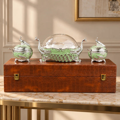 Ornate emerald green peacock dry fruit containers with silver detailing and decorative lids