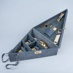 A triangular gray storage case with multiple compartments, shown open on a light gray background. Inside are several metallic gold and gray accessories, including a bottle opener, bottle openers, and small tools.