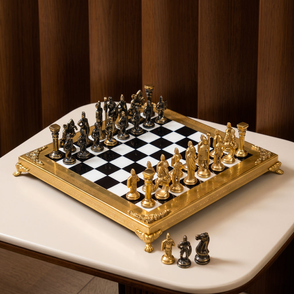 An ornate chess set with a gold-plated frame and metallic gold and bronze figurines, arranged on a black and white checkered board over a white marble surface.