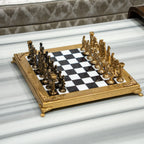 Royal-style chess set displayed on a marble coffee table in a luxury living room.
