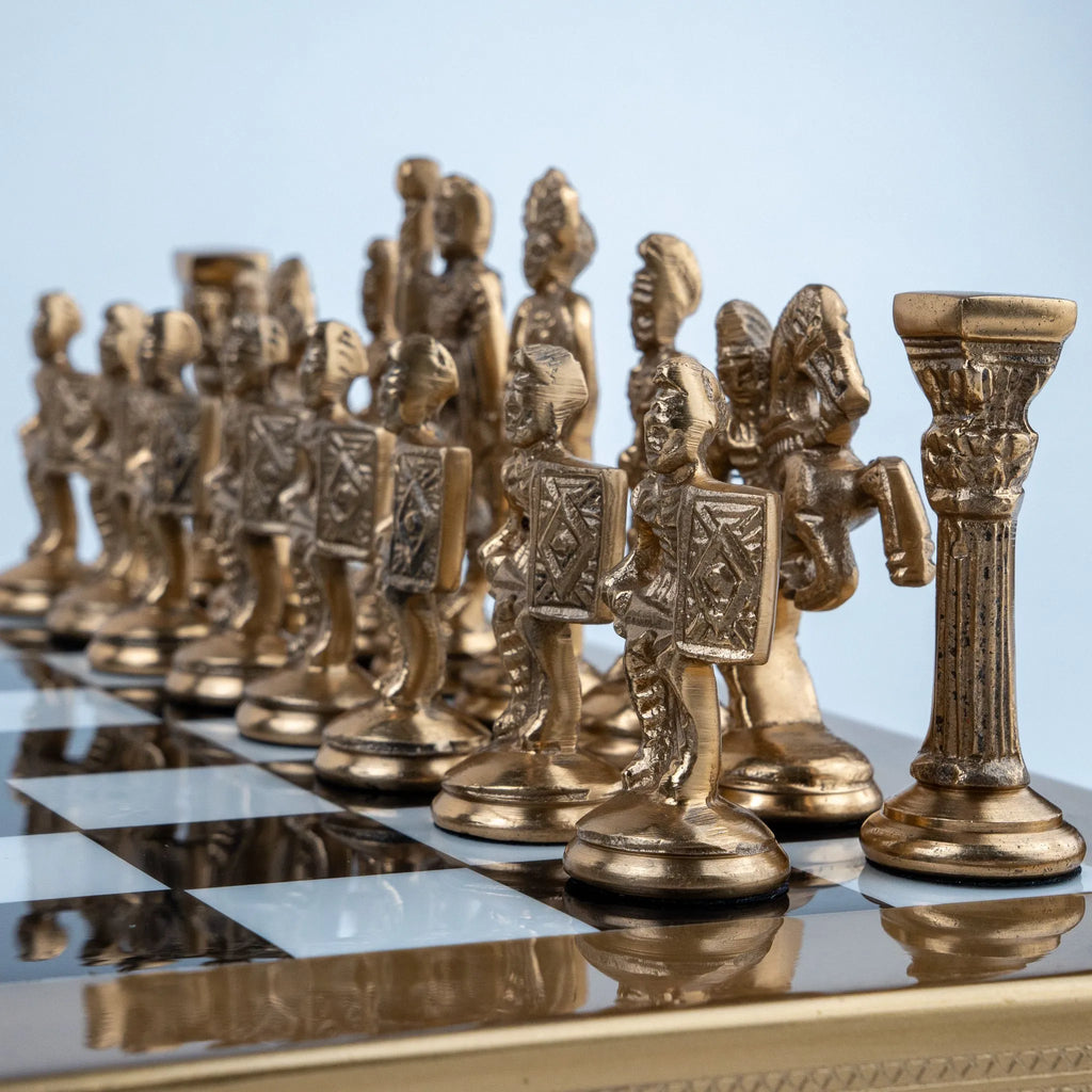 Royal-style chess set displayed on a marble coffee table in a luxury living room.