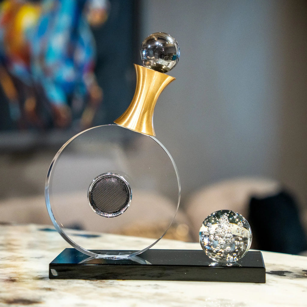 Guitar-inspired home décor accent with transparent circular body and gold-tone details.