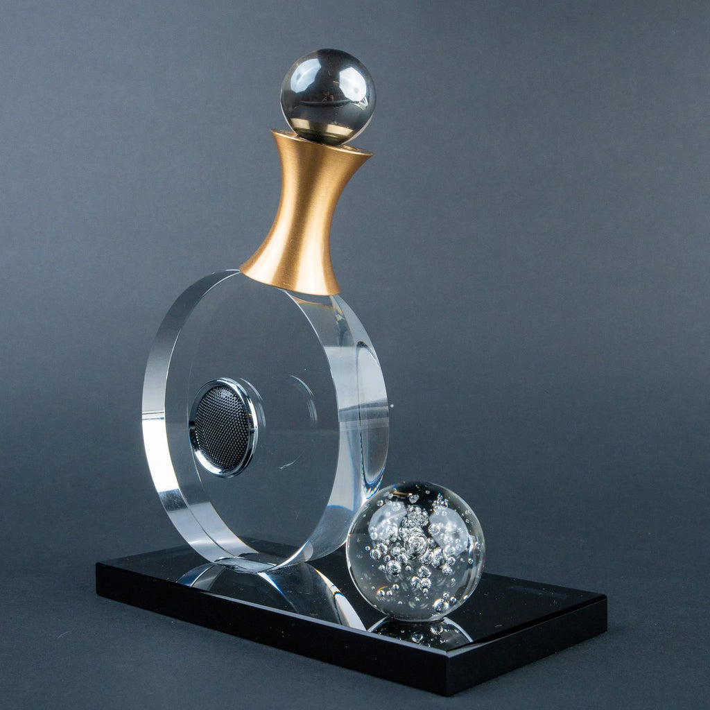 Guitar-inspired home décor accent with transparent circular body and gold-tone details.