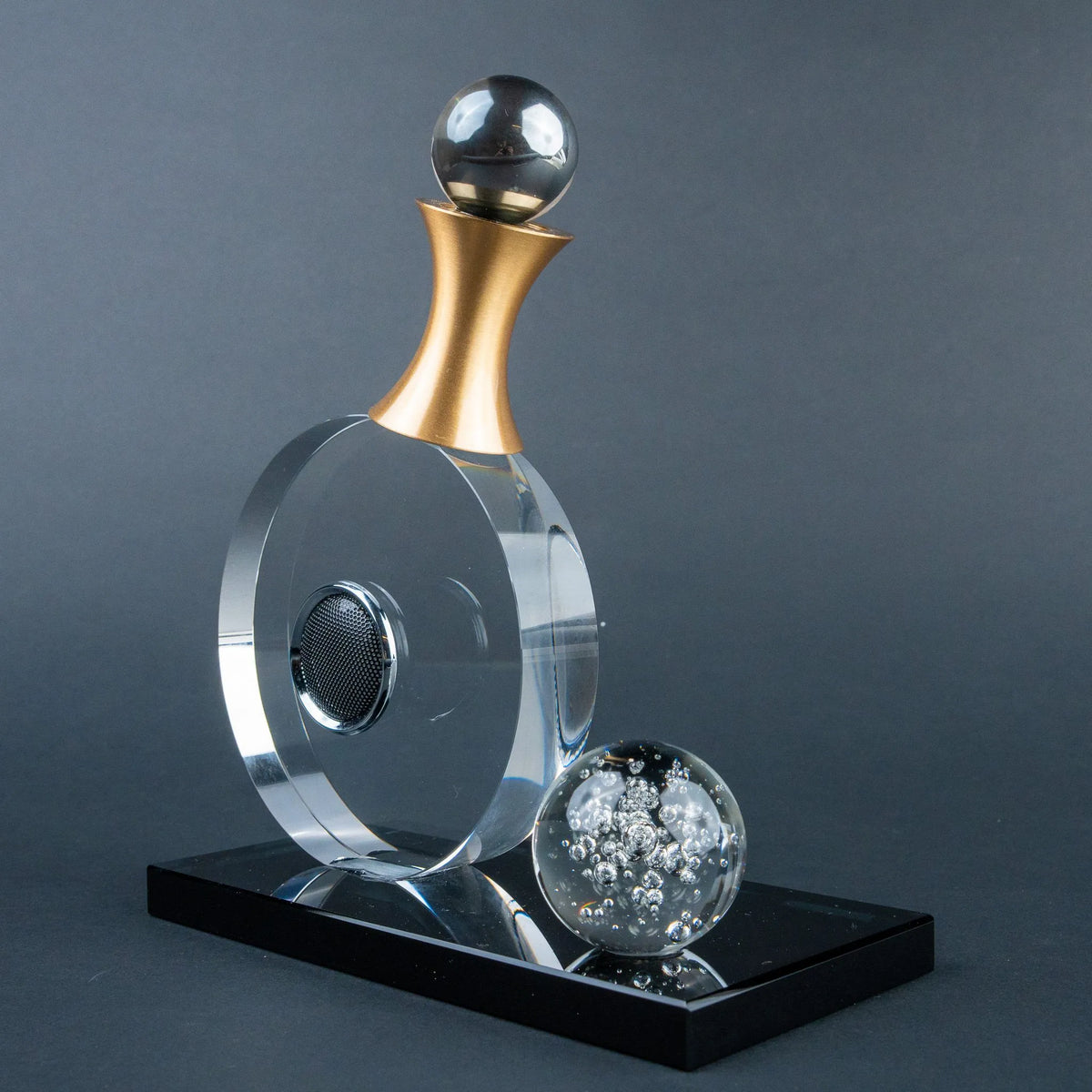 Guitar-inspired home décor accent with transparent circular body and gold-tone details.