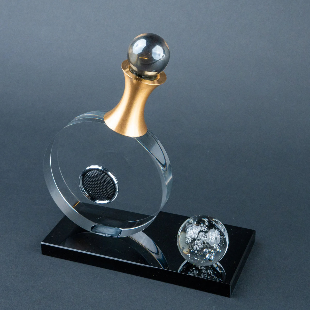Contemporary decorative accent with circular geometry and a contrasting black base.