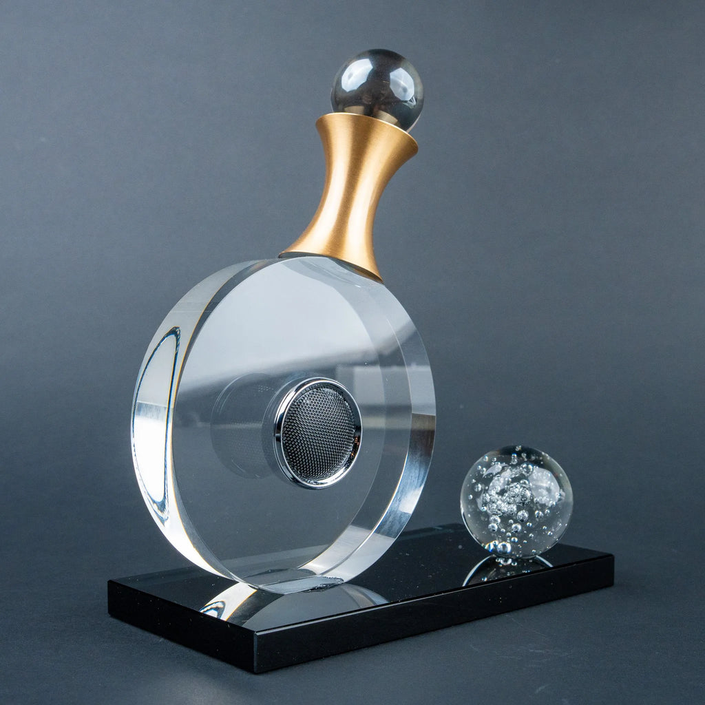 Guitar-inspired home décor accent with transparent circular body and gold-tone details.