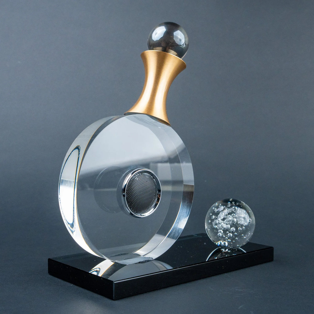 Guitar-inspired home décor accent with transparent circular body and gold-tone details.