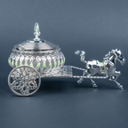 Luxury silver horse-drawn carriage showpiece featuring an intricately crafted ornamental carriage with an elegant domed lidded design, detailed filigree patterns, decorative crystal-like embellishments, finely sculpted horse figurine and beautifully designed spoked wheels. The polished silver finish and elaborate craftsmanship make it an elegant statement piece for luxury home décor, display cabinets and sophisticated interiors.