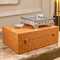 Silver decorative miniature horse-drawn chariot showpiece featuring an intricately detailed rectangular carriage with ornate embossed floral patterns, a transparent reflective top, decorative silver horse figurines, and four beautifully designed ornamental wheels. An elegant luxury home décor accent for tabletops, living rooms, display shelves and premium interiors.
