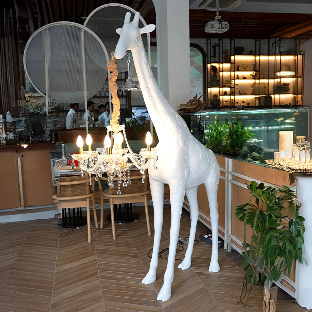 Large white giraffe chandelier sculpture with crystal lighting and gold accents