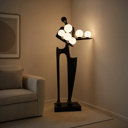 Modern black floor lamp with spherical lights in a room setting.