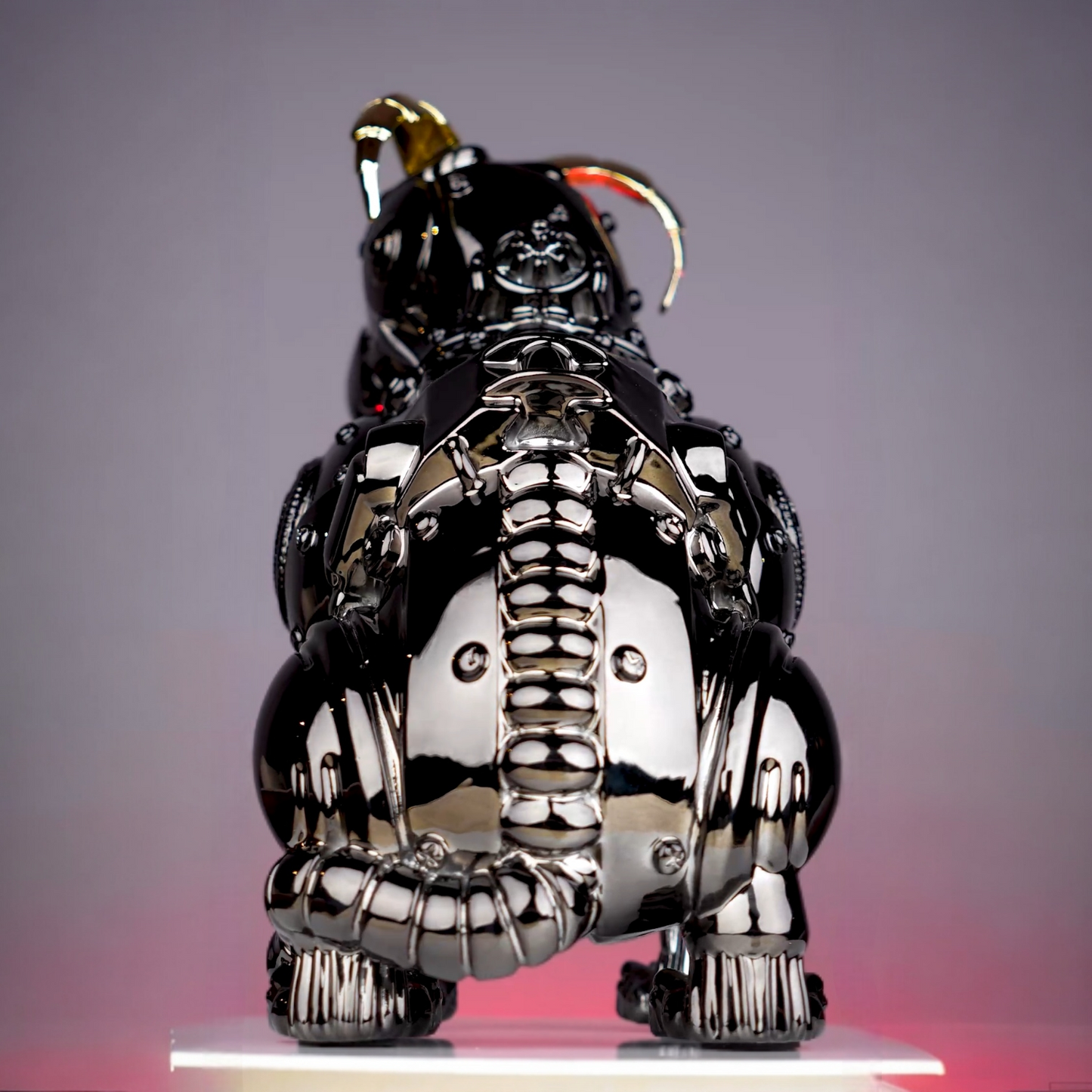 chrome black mechanical dog sculpture with gold accent ears