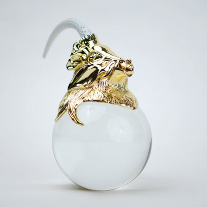 Decorative object with gold lion head and white sphere