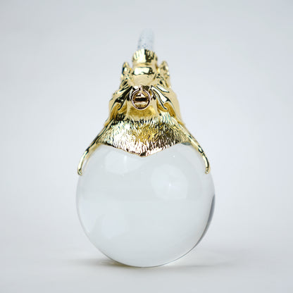 Decorative object with gold lion head and white sphere