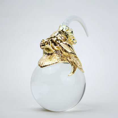 Decorative object with gold lion head and white sphere
