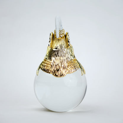 Decorative object with gold lion head and white sphere