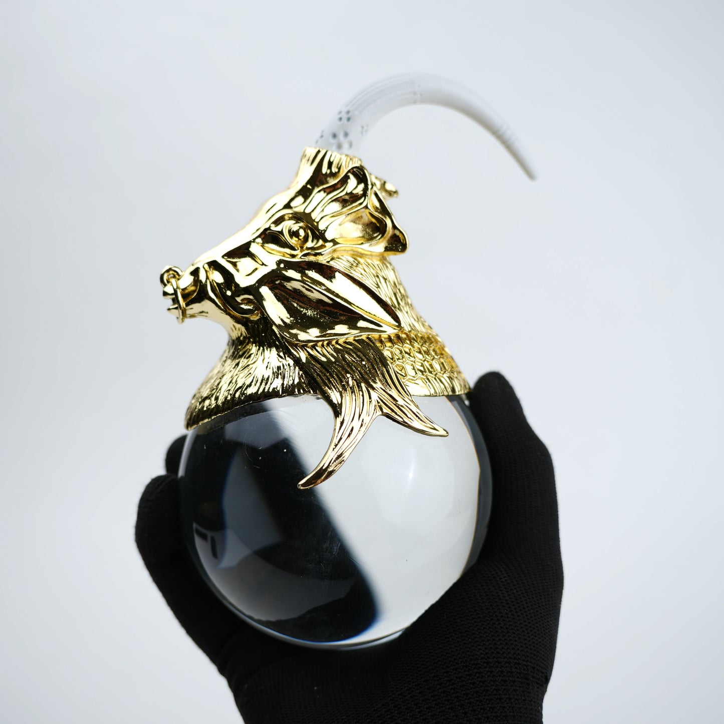 Decorative object with gold lion head and white sphere