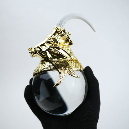 Decorative object with gold lion head and white sphere