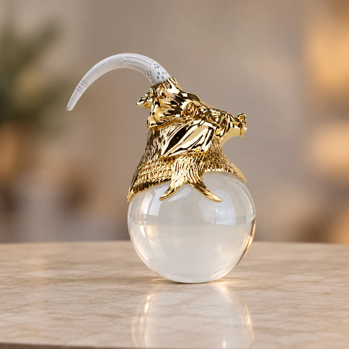 Decorative object with gold lion head and white sphere