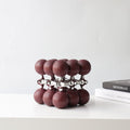 Burgundy spheres on chrome lattice, shelf