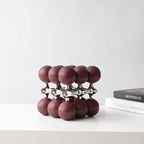 Burgundy spheres on chrome lattice, shelf