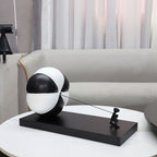 Triumph on side table beside grey sofa
