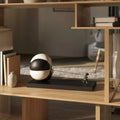 Triumph figure pulling split sphere, oak shelf