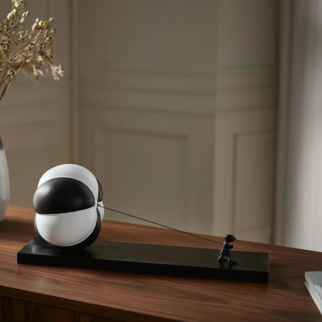 Triumph orb on walnut sideboard w/ flowers